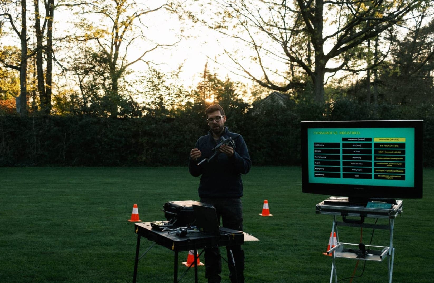 Drone-demonstratie bij valavond, met het live beeld op een groot scherm
